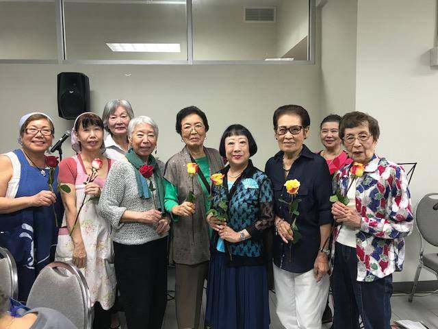 A group of people celebrating Keirokai, posing for a photo
