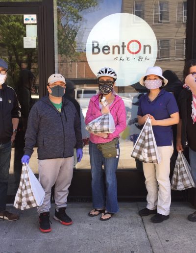 A group of five people wearing masks outside of BentOn